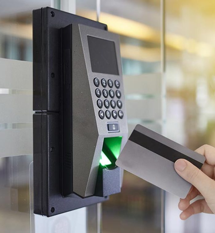 Electronic access control system with keypad and card reader, person using access card for entry, modern security solution for businesses in Wilmington, DE.