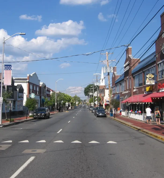Newark DE Main Street view showcasing local businesses, parked cars, and vibrant storefronts, relevant to Nova Locksmith's services in the area.