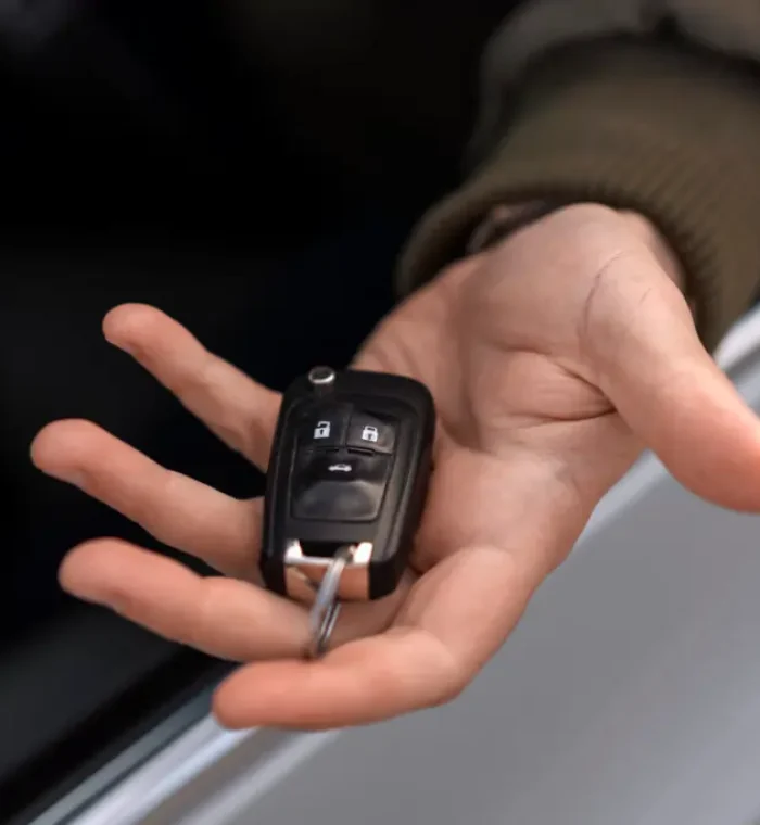 high-angle-hand-holding-car-key-2-1024x683
