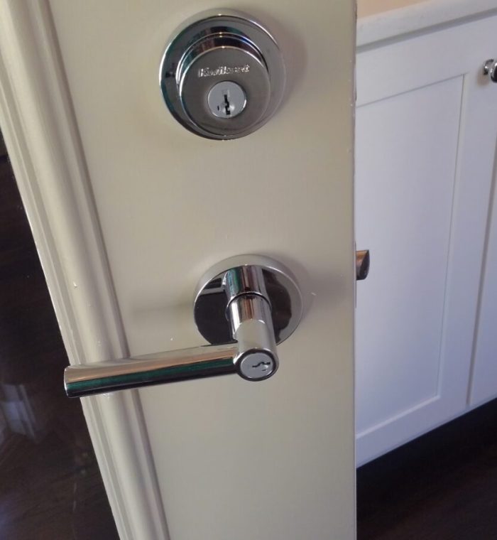 Door handle and lock mechanism showcasing a secure entryway, relevant to Nova Locksmith's rekeying services for enhanced home and business security.