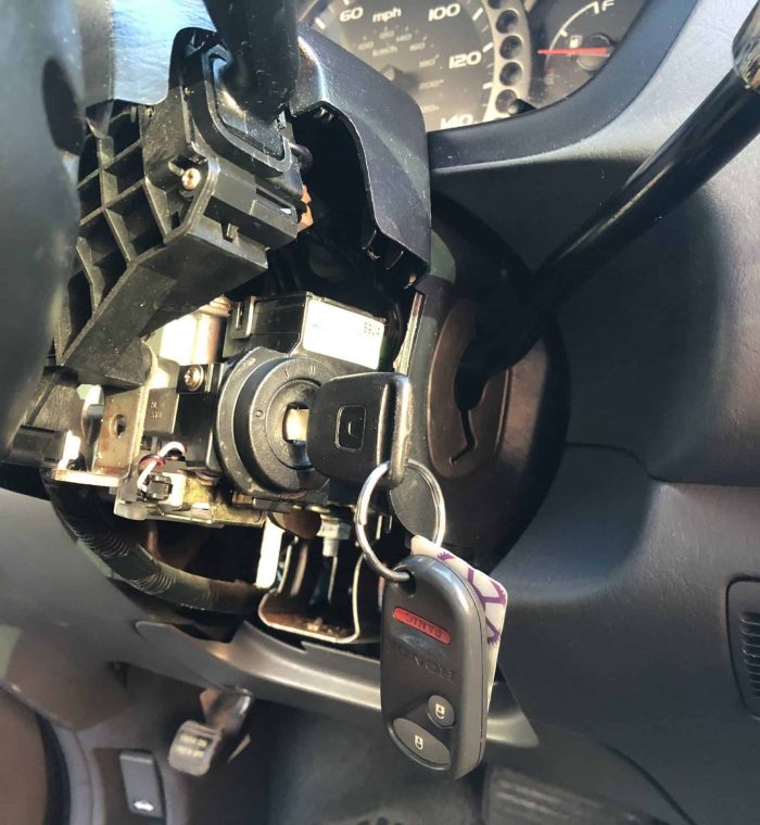 Car ignition system with a key inserted, showing signs of wear and potential malfunction, relevant to ignition replacement services by Nova Locksmith.